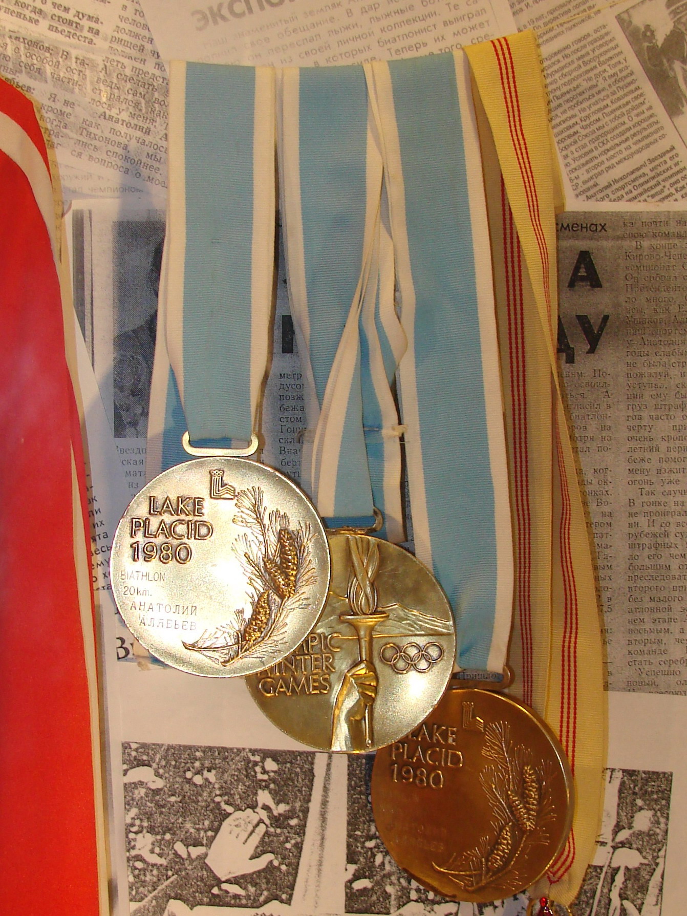 Two gold and bronze Olympic medals from XIII Olympic Winter Games, designed by Gladys Gunzer